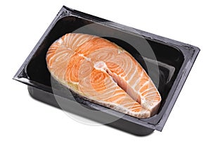 One fresh raw Norwegian salmon steak in a black plastic box