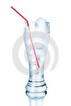One full transparent glass of cool crystal clear water, ice cubes and red drinking straw, reflection, white background isolated
