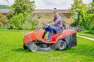 One gardener driving riding lawn mower garden