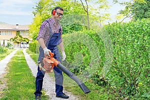 One gardener holding and using leaf blower