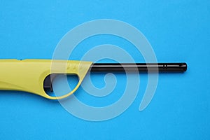 One gas lighter on blue background, top view