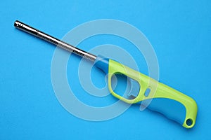 One gas lighter on blue background, top view