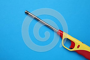 One gas lighter on blue background, top view. Space for text
