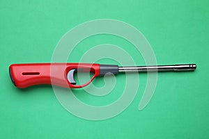 One gas lighter on green background, top view