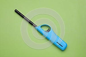 One gas lighter on green background, top view