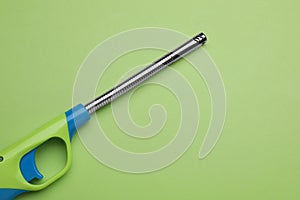 One gas lighter on green background, top view. Space for text