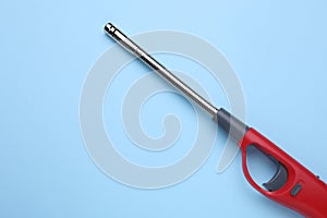 One gas lighter on light blue background, top view. Space for text