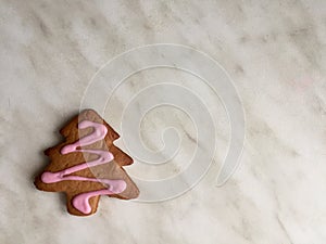 one ginger herringbone-shaped cookies, with pink icing sugar. ginger biscuits in herringbone form with pink icing sugar, grey