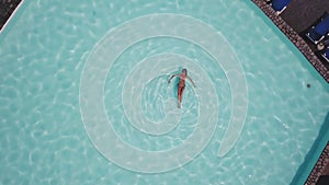 One girl enjoying an empty swimming pool with crystal clear water