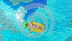 One girl lying on a rubber mattress in a pool. Sea Luxury Vacation concept.