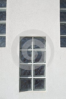 One glass block window looking outside on wall