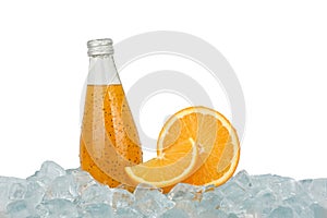One glass bottle of orange drink on ice