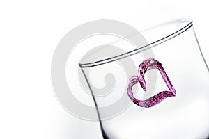 One glass with heart shape in purple color