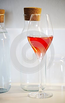 One glass of rose wine on white background