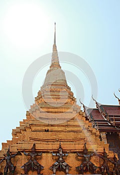 One of the golden chedi with the supporting giants around the base, , Wat Phra Kaew, Bangkok, Thailand photo