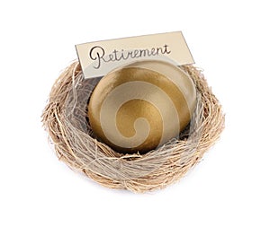 One golden egg and card with word Retirement in nest on white background. Pension concept