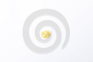 One golden inflated corn flake isolated on white backdrop top view,