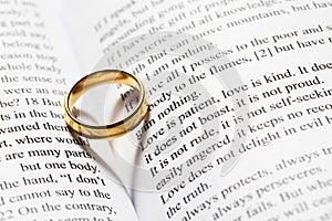 Golden wedding ring on bible book