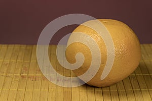 One grapefruit on a bamboo background