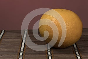 One grapefruit on a bamboo background