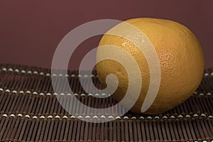 One grapefruit on a bamboo background