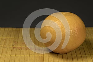 One grapefruit on a bamboo background