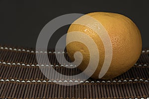 One grapefruit on a bamboo background