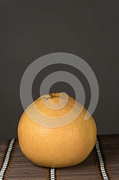 One grapefruit on a bamboo background