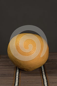 One grapefruit on a bamboo background
