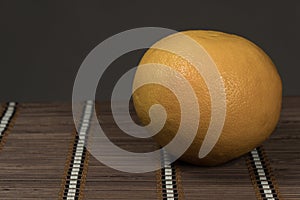 One grapefruit on a bamboo background