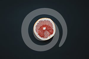 One grapefruit on dark background.