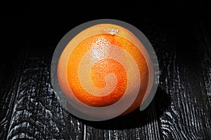 one grapefruit on wood