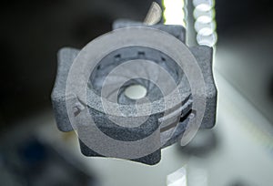 One gray model camera shutter printed on 3D printer. Object printed 3D printer