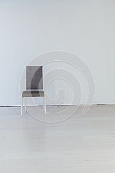 One gray vintage chair in an empty white room