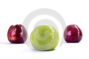 Isolated One green apple and two red apples on a white background