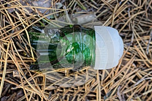 one green broken glass bottle neck with a white plastic cap