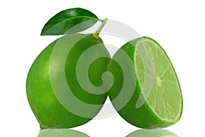 One green lemon fruit with leaf and a half