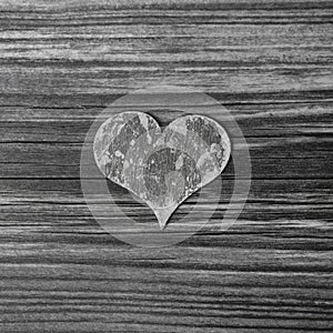 One grey wooden heart on shabby chic background.