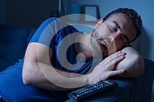One man sleeping and snoring watching television