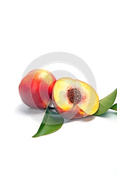 One and a half nectarine peaches on white background