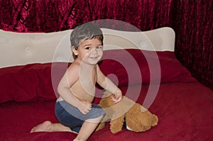 One and a half year old baby boy posing with teddy bear