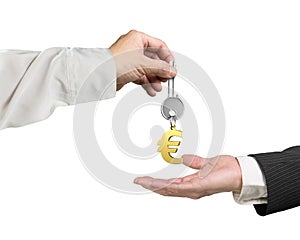 One hand giving key Euro sign keyring to another hand