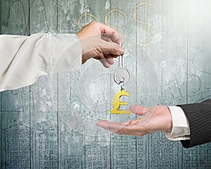 One hand giving key pound symbol keyring to another hand