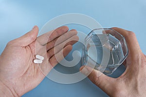 In one hand one bright pill in another many in shadow. concept of effective medicine