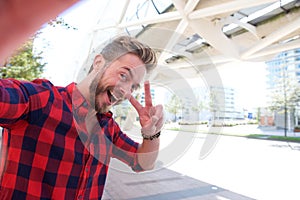 One handsome smiling man taking fun selfie