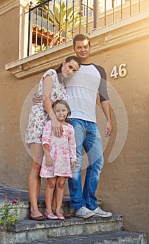 One happy family. Portrait of a happy family standing outside their house.