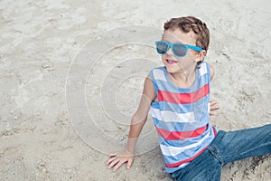 One happy little boy playing on the beach at the day time