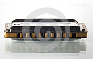 One harmonica on a white background