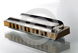 One harmonica on a white background