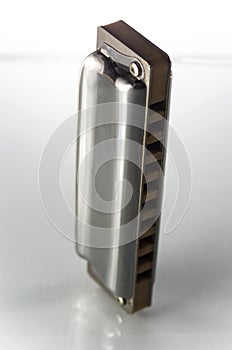 One harmonica on a white background